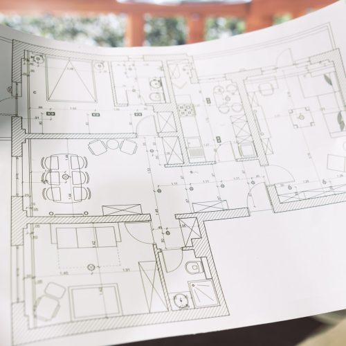 Professional businessman reviewing architectural blueprints for new office hunt